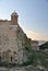 Old fortress wall with a turret in the evening light