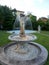 An old fountain with a woman sclupture in a romanian house yard.