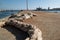 Old, frayed mooring rope lying on ground at fishing dock. Low angle