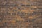 Old, frayed yellow brick wall texture, background