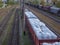 Old freight train with many wagons staying at depot in the city