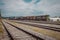 Old freight train with old and noisy diesel engine. Mixed waggons on a cloudy day