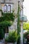 Old French house with a climbing plant and a wrought-iron balcony in Mougins in Provence