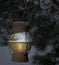 Old frosted lantern hanging in a snowy tree