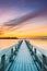 Old Frosted Wooden Boards Pier On Calm Water Of Lake Or River Or Sea At Evening Or Morning Time. Sunset Sunrise In