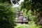 Old Galicia Ukrainian Orthodox church, traditional wooden building in green leaves, beautiful spring