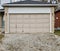 Old garage door with a gravel driveway