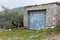 Old garage made of stone with No Parking written on door