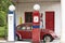 Old gas petrol station. Petrol pump and antique beetle car