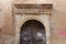 old gate with a sculpted stone arc and wood doors in rethymno in crete (greece)