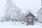 An old gatehouse in the middle of a snowy courtyard. near the warehouse