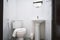 Old, Generic toilet room of apartment or small hotel with flush toilet, washbasin and flip glass mirror