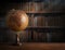 Old geographical globe and old book in cabinet with bookselfs. Science, education, travel background. History and geography team.