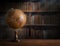 Old geographical globe and old book in cabinet with bookselfs. Science, education, travel background. History and geography team.