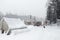 Old geological field camp of gold diggers in winter. The dog sits among the old tents