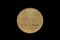 An old, gold Finnish coin shot on a black background