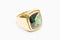 Old golden ring carrying big emerald deep green and precious