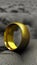 The old golden ring lies on the dry gray ground. The lost jewel is lying on the dirty ground. Generated AI.