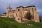 Old gothic style catholic church back view with a dramatic sky in palencia, spain