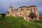 Old gothic style catholic church back view with a dramatic sky in palencia, spain