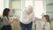 Old Grandmother Dancing In The Kitchen With Two Little Great-Grandchildren.