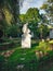 Old grave with a monument to a famous person in the cemetery. Architectural stone statue,old historic grave and funeral monument