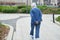 Old gray-haired, elderly woman walking in the Park