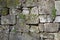 Old gray mossy limestone wall background