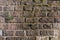 Old gray vintage weathered brick wall texture of ancient castle. Grunge rough block stonewall, masonry structure surface