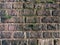 Old gray vintage weathered brick wall texture of ancient castle. Grunge rough block stonewall, masonry structure surface pattern