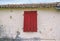 Old Greek house with dirty wall and wooden shutters