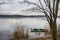 Old, green, boat submerged in the water at the bank of the pond on the Mala Panew river in Kalety Zielona in Poland