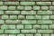 Old green brick wall, rustic texture, design background