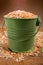 Old green bucket filled with oatmeal