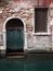 Old green door in an ancient brick building