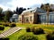 Old green house in beautiful formal garden. in public park with spring flowers in Stuttgart, Germany, Europe