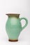 Old green milk jug on the white background