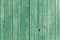 Old green painted weathered wooden planks