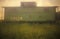 An old green railroad boxcar atop a hill in Cairo, Illinois