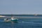 Old green and red fishing boats anchored in calm w