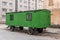 Old green trailer on a road