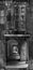 Old green wooden window and below street passage through columns of the old town of Pontevedra