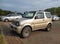 Old grey silver Suzuki Jimny 4wd car with two doors parked