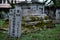 Old grey tombstones. Cemetery in Malaysia