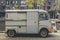 Old grey truck parked in the city near the canal