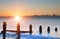 Old groynes on beach last defense at sunrise against tide