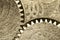 Old grunge texture of steel gears. Macro. Sepia