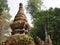 Old grungy small pagoda  chedi  abandoned in a forest - Buddhist religious architecture