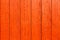 Old grungy and weathered red orange painted wooden wall plank simple texture background