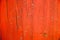 Old grungy and weathered red and orange painted wooden wall plank texture background